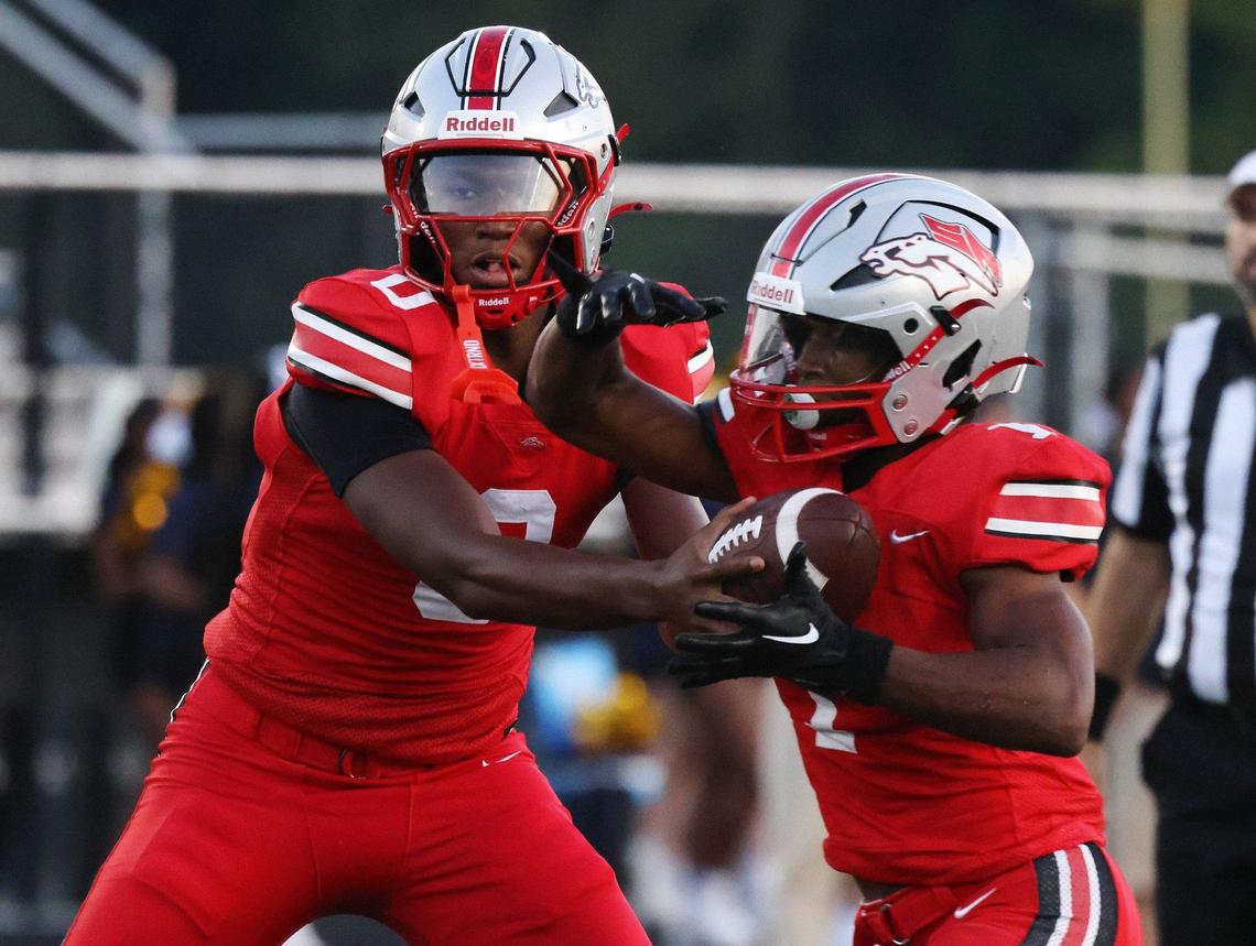 South Pointe’s J’Zavien Currence (0) hands off the ball to Mason Hicks Friday as the Stallions take on Spartanburg in Rock Hill.