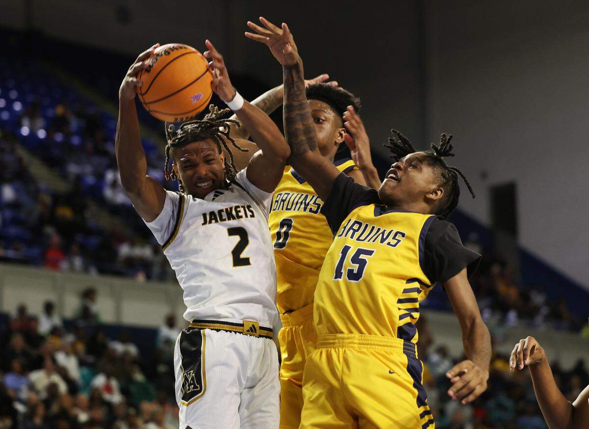 North Augusta’s Toian Nabriat (2) and Lancaster’s Jordan Watford (2) and Niquan White fight for control of the ball Friday at the Class 4A state championships in Florence