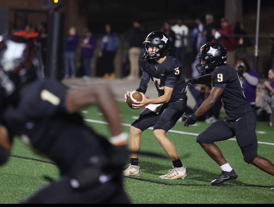 Rock Hill quarterback Jonah Young looks before handing the ball to Devan Erby Friday, Oct. 17, 2025 in Rock Hill, S.C.