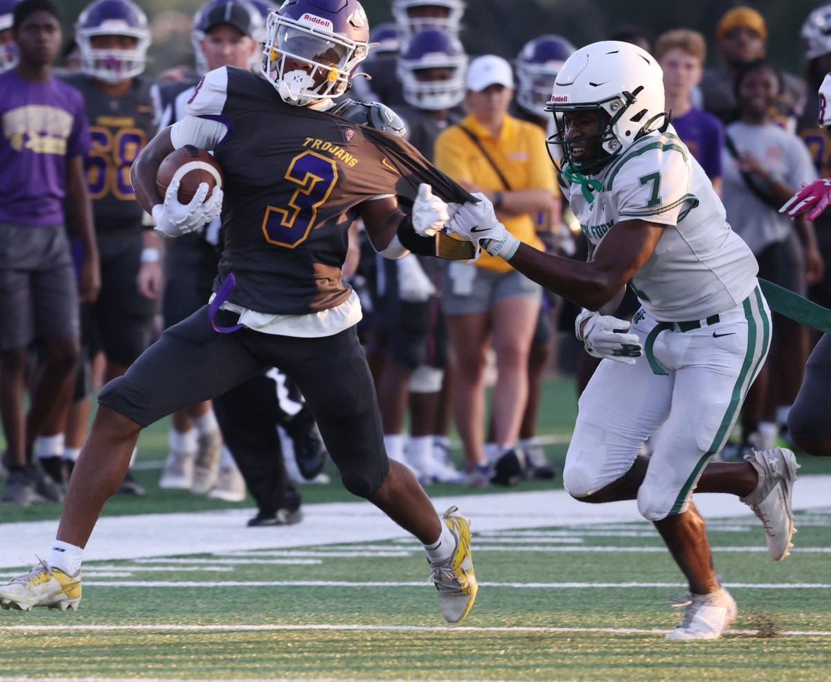 Dutch Fork’s Elgin Sessions pulls on Northwestern’s Kameron Vance at the WRHI Football City USA scrimmage in Rock Hill.