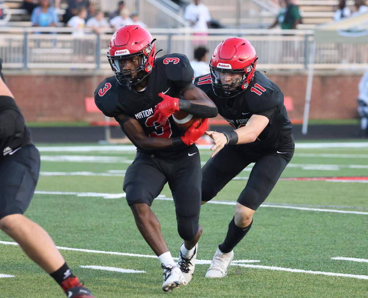 Nation Ford’s Kaden Barnett hands the ball off to Kaleb White (3) as the Falcons take on the Catawba Ridge Copperheads on Friday, Sept. 1, 2023 in Fort Mill, S.C.
