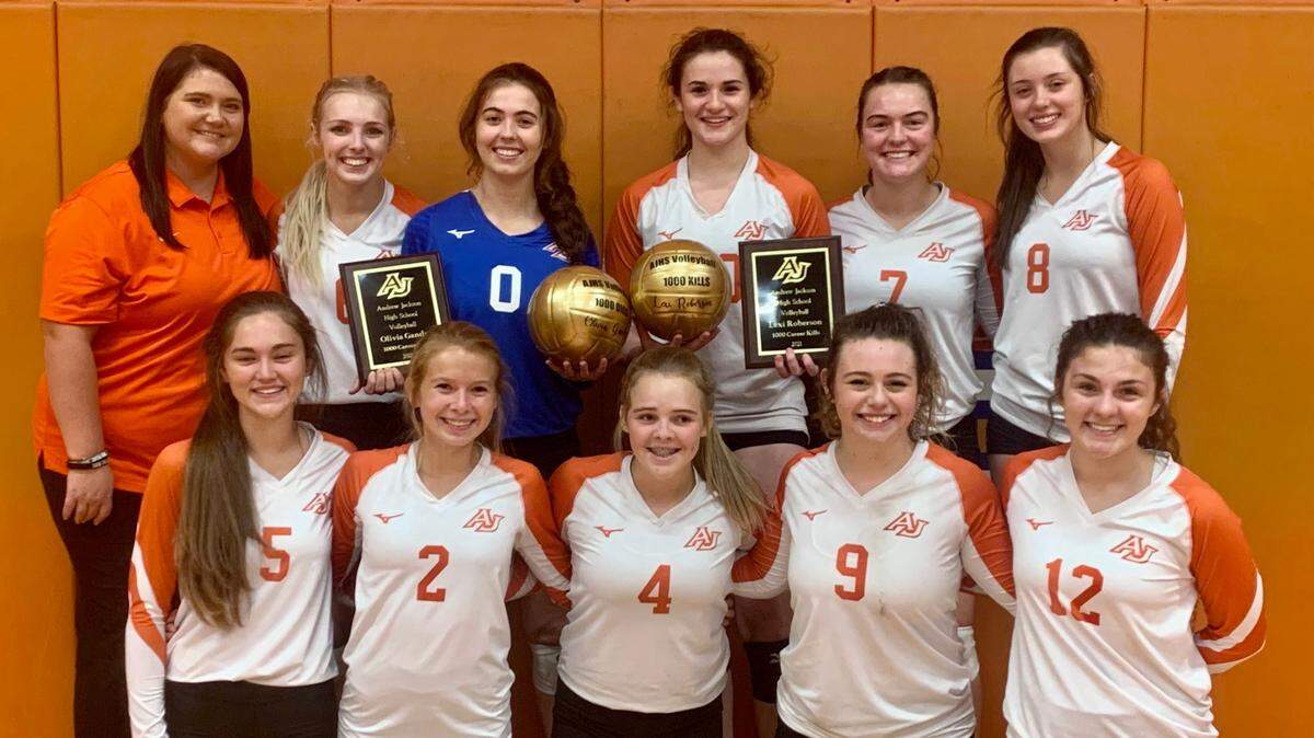 The Andrew Jackson volleyball team poses for a picture after a recent win with its coach, Hannah Kirkley.