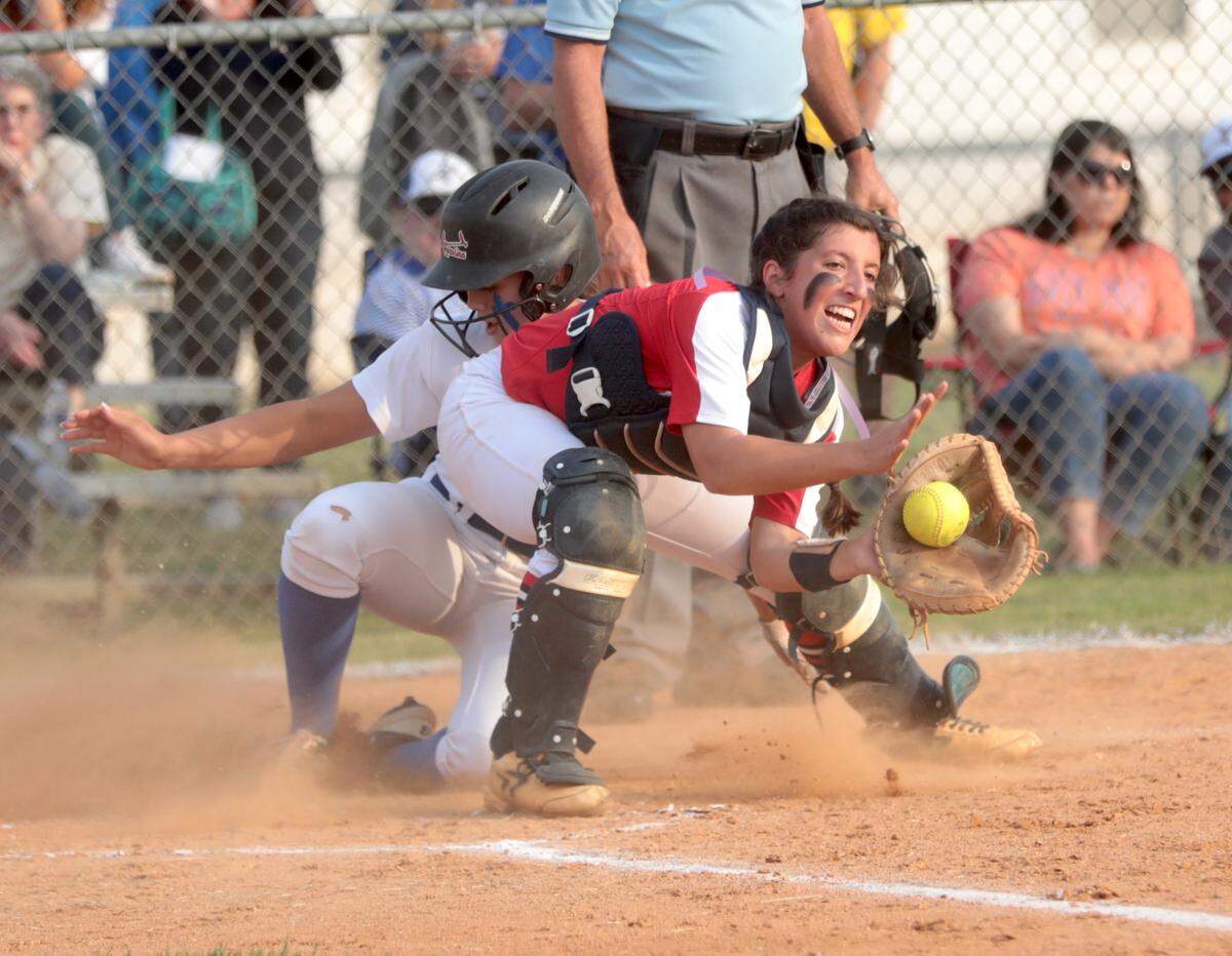 Indian Land’s Savanna Nyugen slides safely into home base as Lugoff-Elgin’s Tomie Christofaro catches the ball Monday in Indian Land