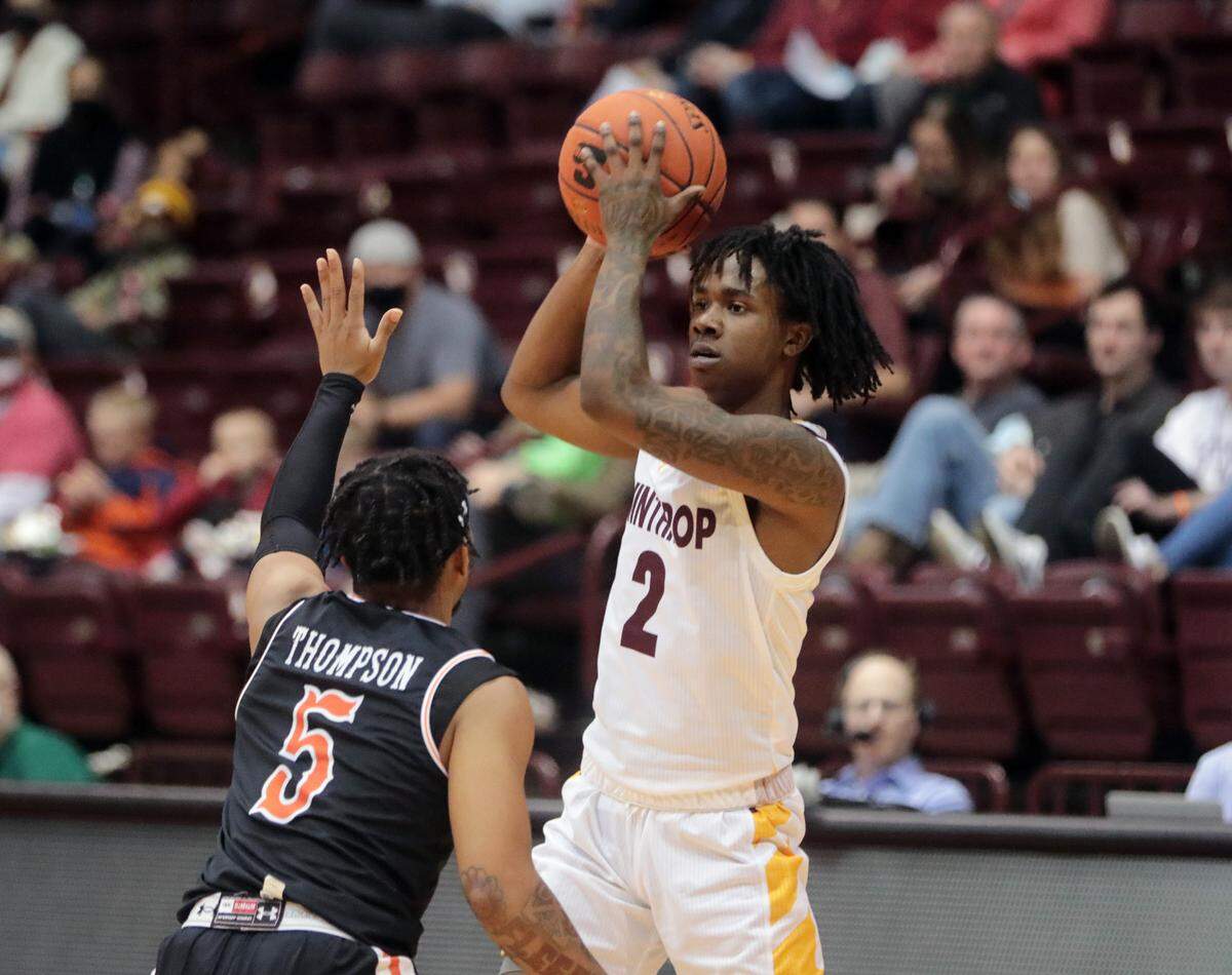 Winthrop’s Sin’Cere McMahon looks for an opening around Campbell’s Messiah Thompson.