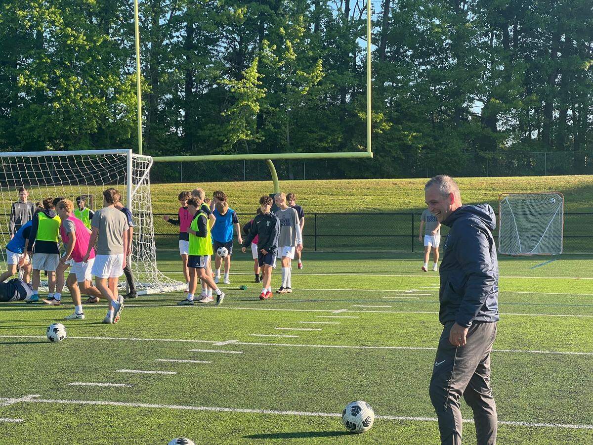 Clover boys soccer head coach Graham Stafford laughs as his team trains during practice.