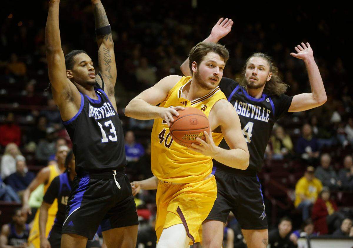 Winthrop’s Alex Timmerman (40) looks for an open against Asheville’s Nick McMullen (13) and Drew Pember