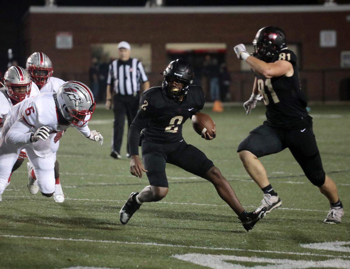 Rock Hill’s Matthew Wilson (2) tries to avoid South Pointe’s Quan Peterson (6) as Rock Hill’s Robbie Ouzts (81) follows Friday as the Bearcats and Stallions meet at District Three Stadium.