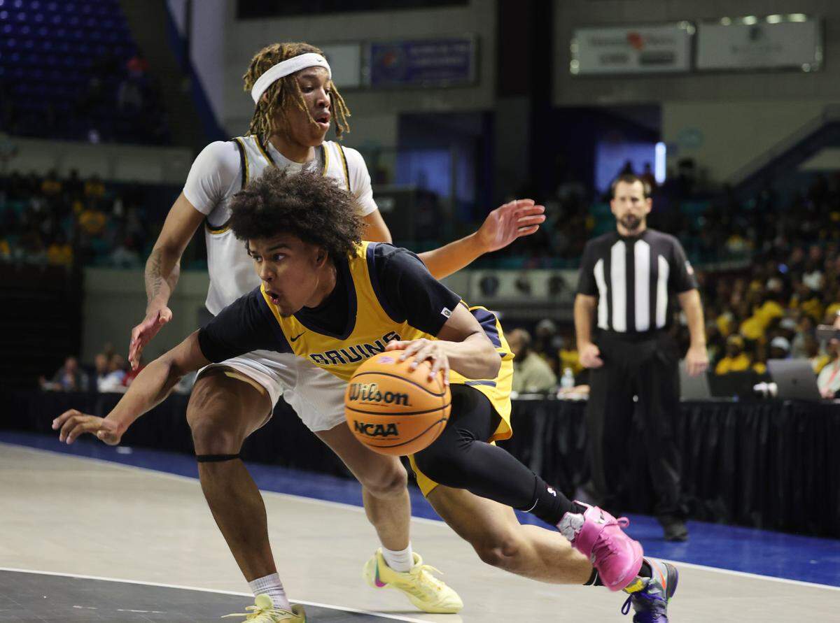 Lancaster’s Columbus Parker stumbles to the basket against North Augusta’s Quh’mareon Webb