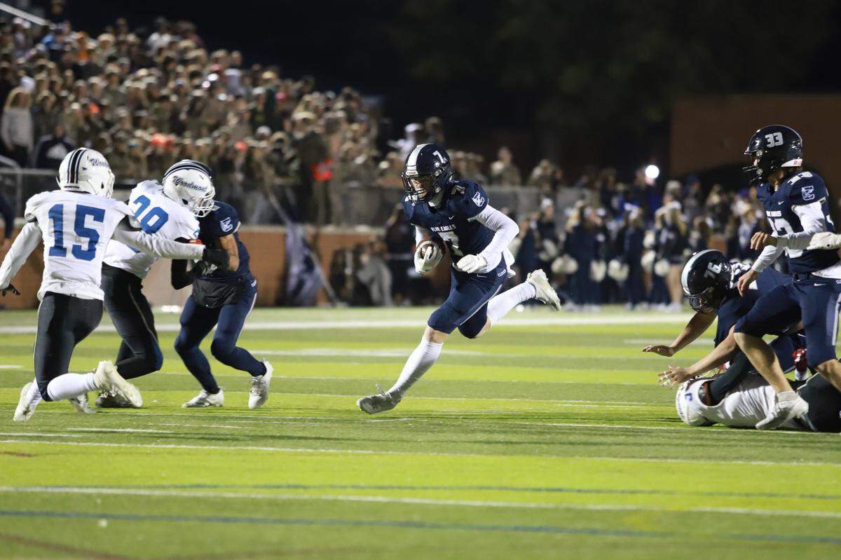 Landon Stone (7, dark blue) ran for two scores and caught another one in the Blue Eagles 31-14 victory