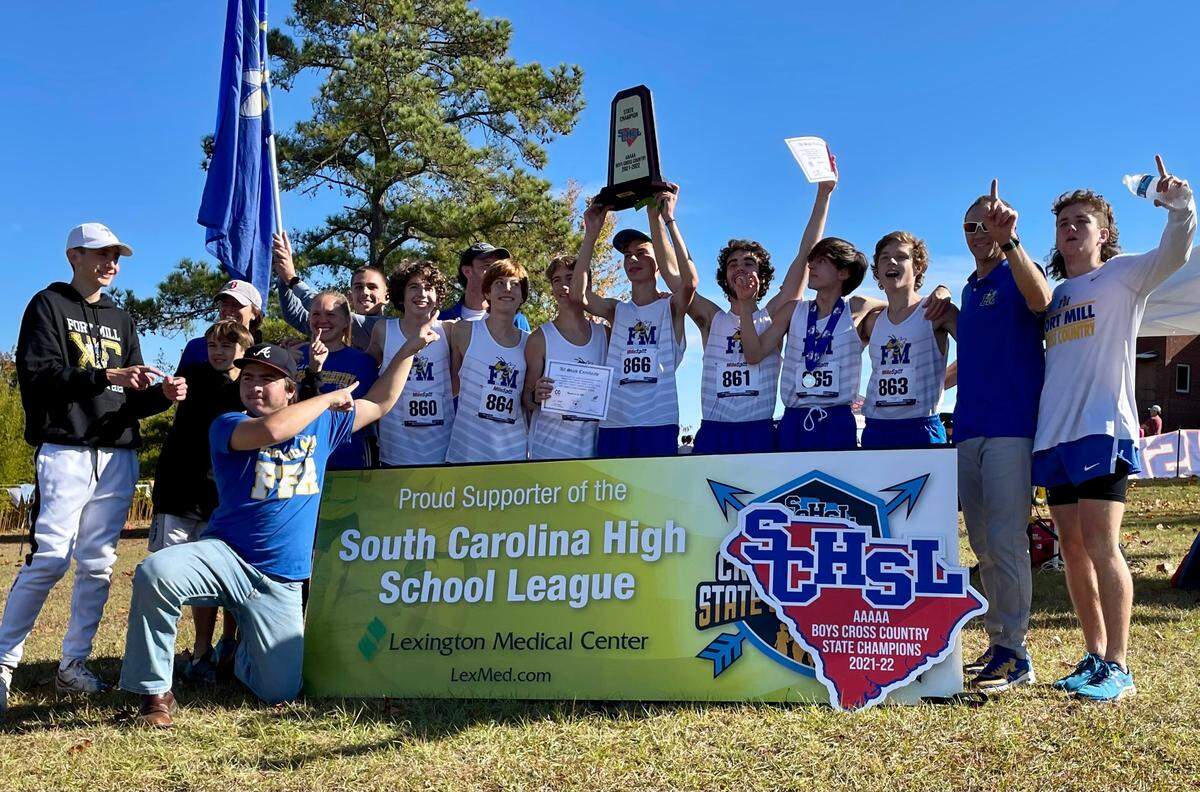 The Fort Mill boys’ cross country team pose for a team photo after a 5A state championship on Friday in Columbia.