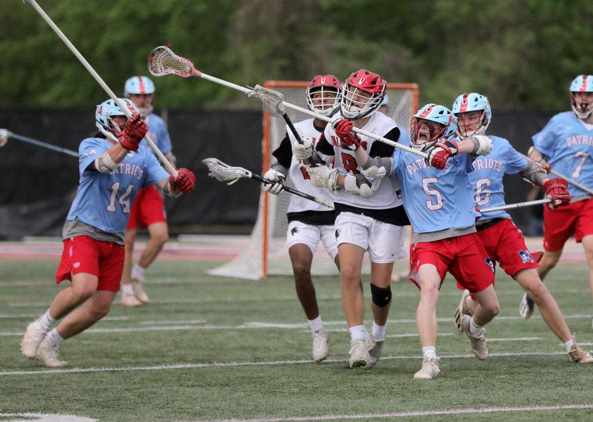 Nation Ford’s Luke Letterhos (8) and J.L. Mann’s Clinton Bissinger (5) head for the ball.