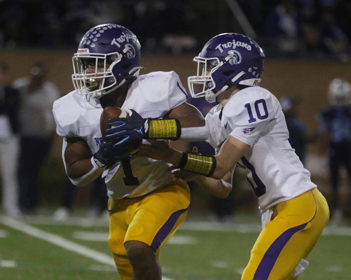 Northwestern quarterback Finley Polk (10) hands the ball off to Turbo Richard.