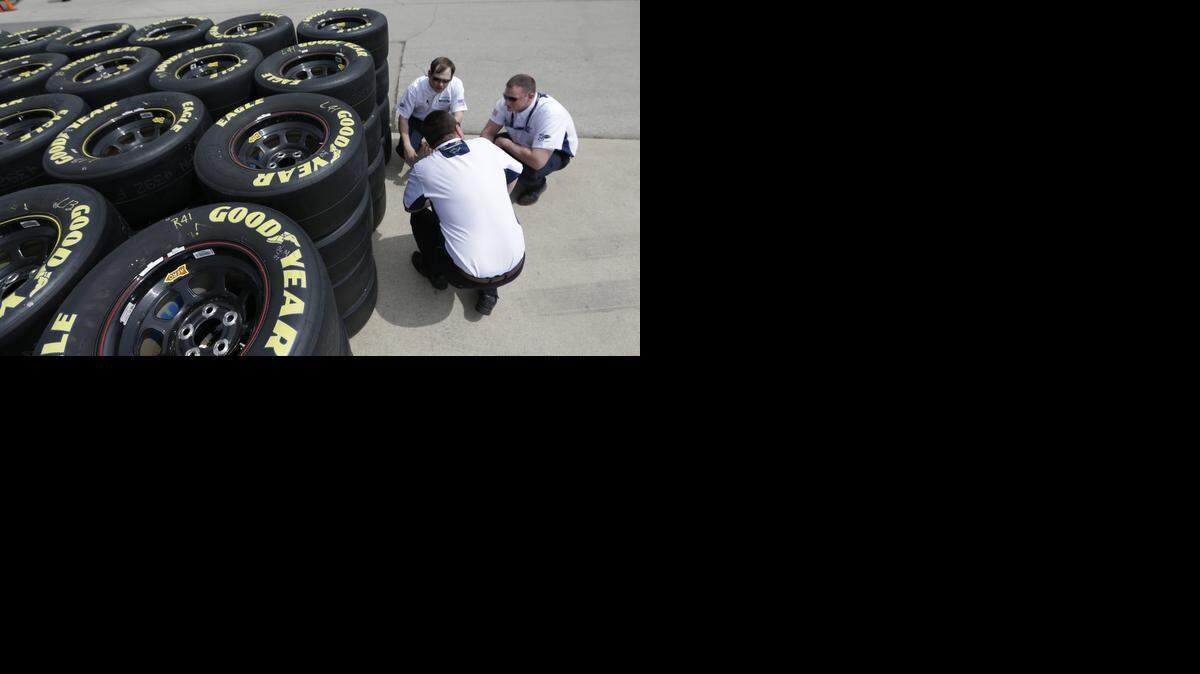 
In this April 3, 2014, file photo, Goodyear tire technical officials, whom did not which to be identified, discuss tires at the Texas Motor Speedway in Fort Worth, Texas.
