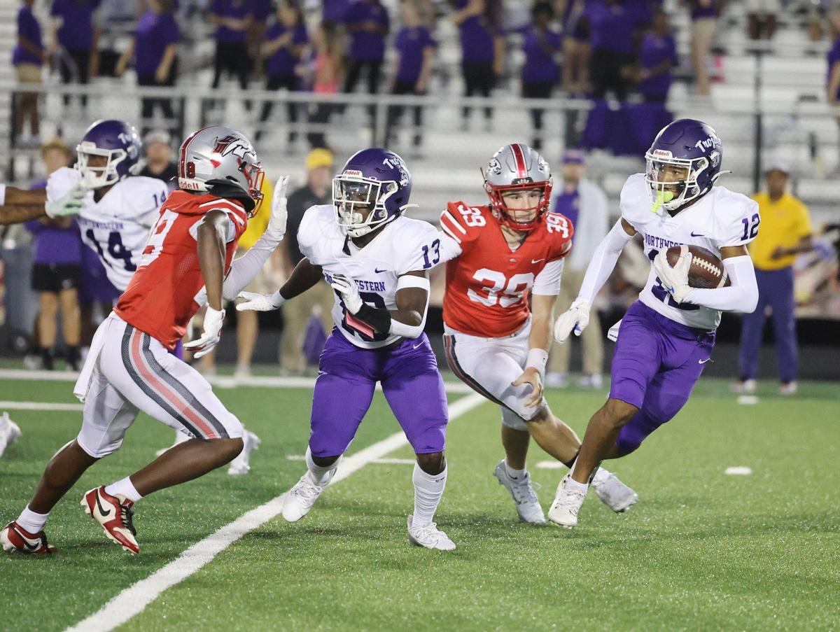 Northwestern’s C.J. Broughton (13) tries to keep South Pointe’s Zahyden Ratliff, left, as Jonathan Spurgeon (12). carries the ball. South Pointe’s Ethan Mick (39) runs nearby.