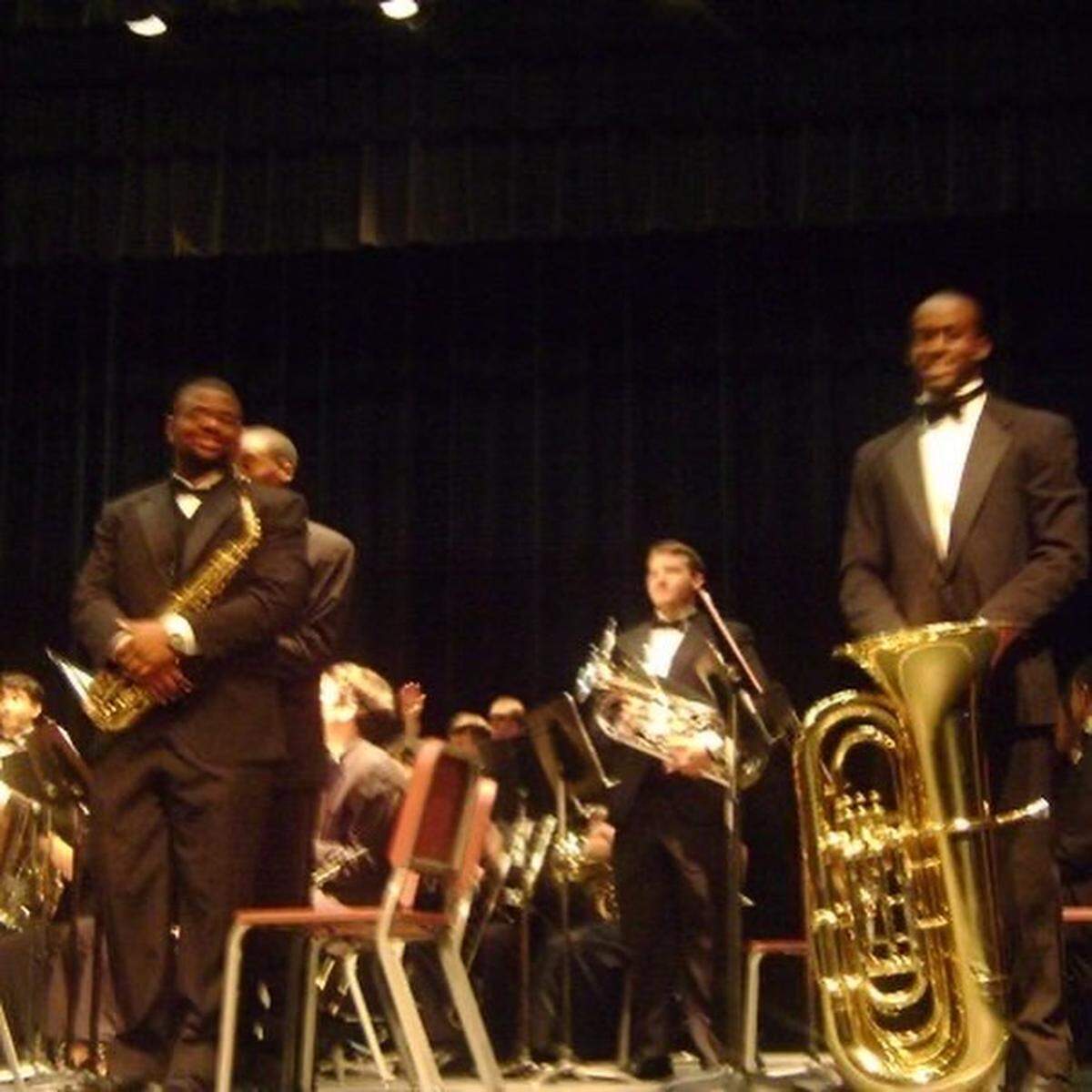 Asa Watson (far right, holding tuba) and Brett Saunders (far left, holding saxophone) played both in the band and on the football team together.
