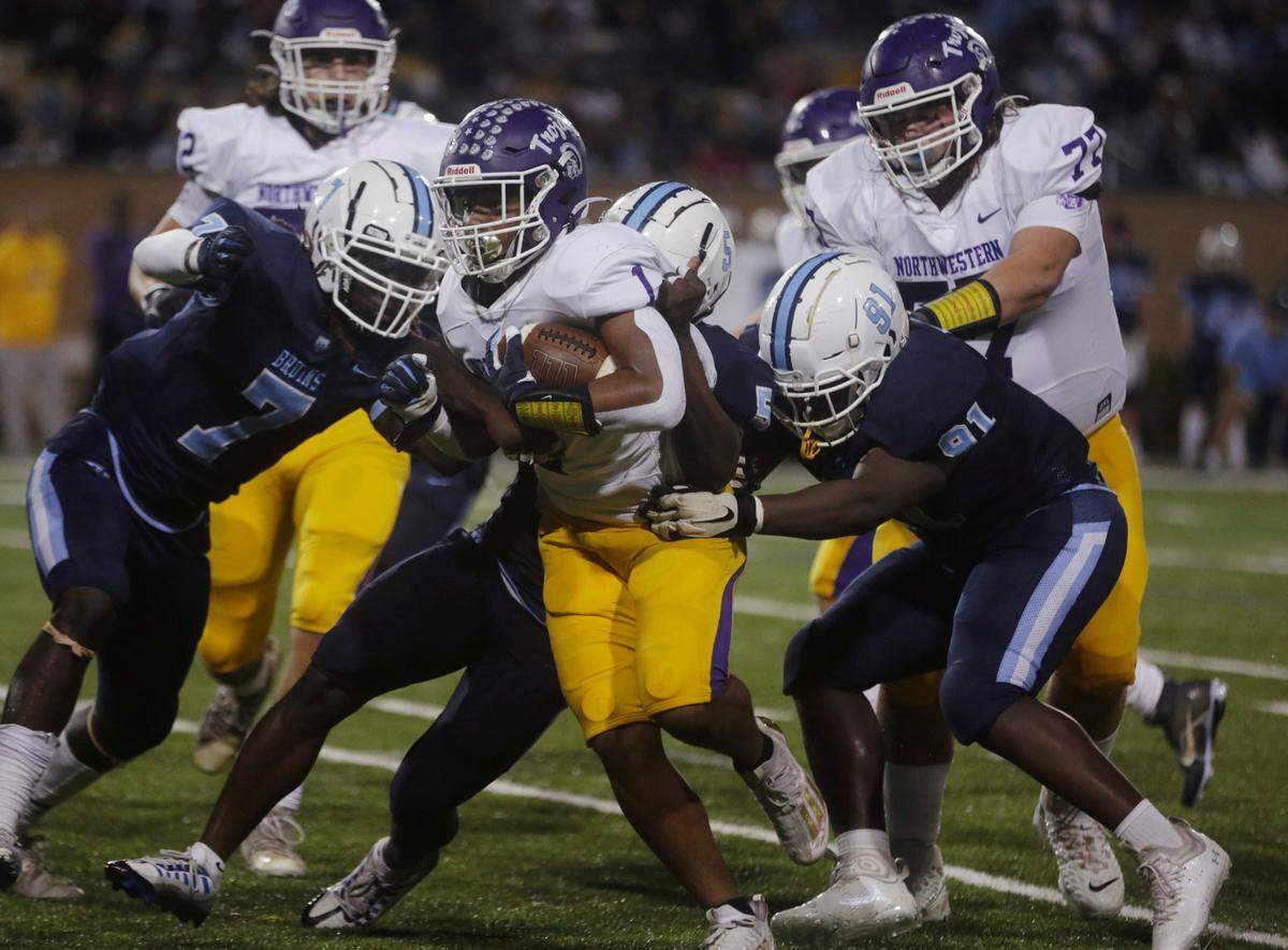 Northwestern’s Turbo Richard (1) is brought down by South Florence’s Chantwan Harkless Jr. (7), Trokel Prew (5) and Richard Hobbs (91).