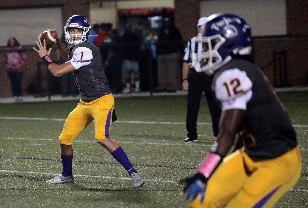 Northwestern’s Will Mattison throws the ball to Calique Cunningham Friday as the Trojans take on the Bearcats in Rock Hill.