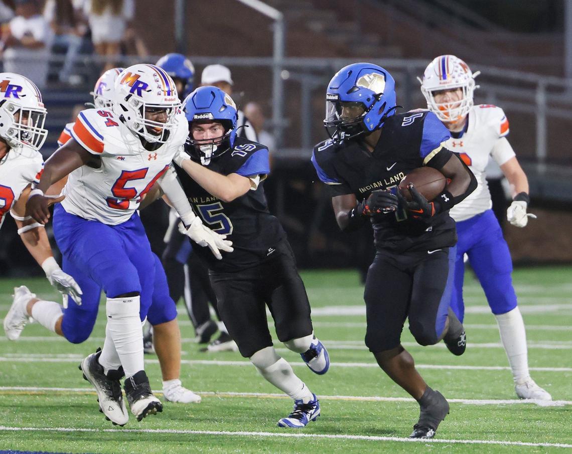 Indian Land’s Jamol Horton carries the ball against Marvin Ridge’s P.J. Belabe (54) during a 2024 game.