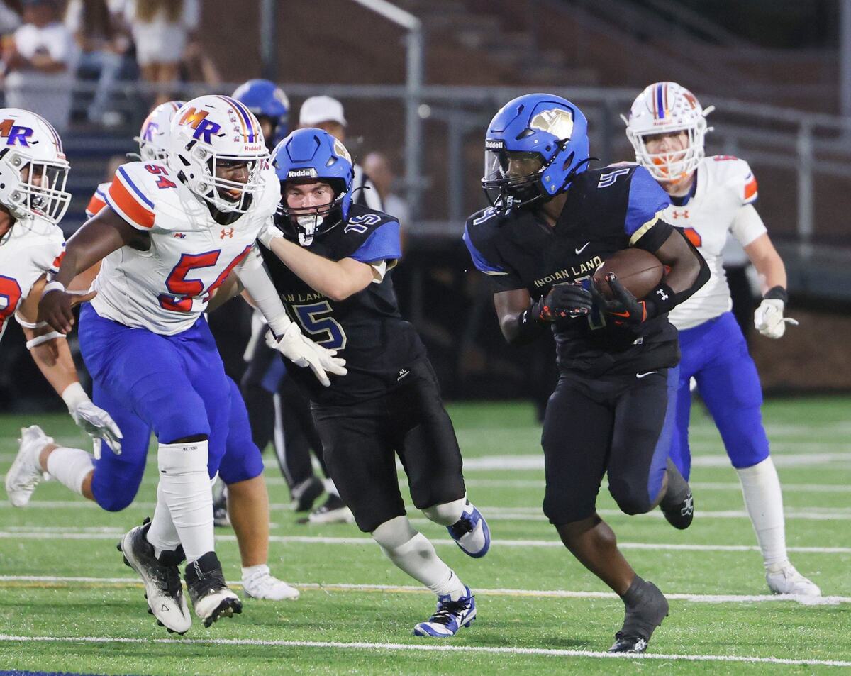 Indian Land’s Jamol Horton carries the ball against Marvin Ridge’s P.J. Belabe (54)