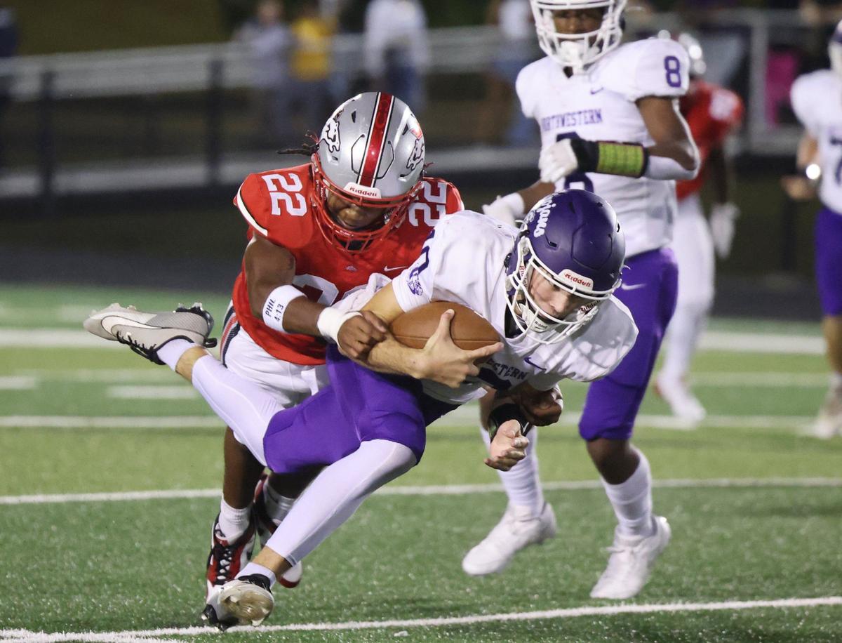 Northwestern’s Finley Polk is tackled by South Pointe’s Zy’quavious Pickett Friday as the Trojans take on the Stallions in Rock Hill.