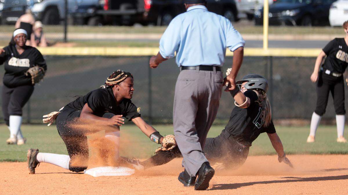 Janelle Ilacqua slides into first base as Greer’s Kristin Griffin tries to tag her Friday at Catawba Ridge High School.