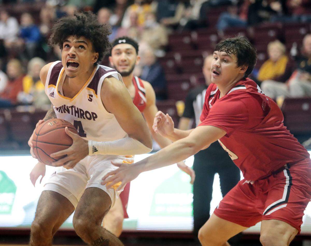 Hartford’s David Shriver puts pressure on Winthrop’s Kelvin Talford as he heads to the basket.