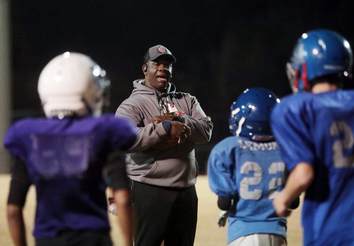 Rock Hill Gra-Y football coach Perry Sutton talks to his team Monday during practice at Hargett Park.