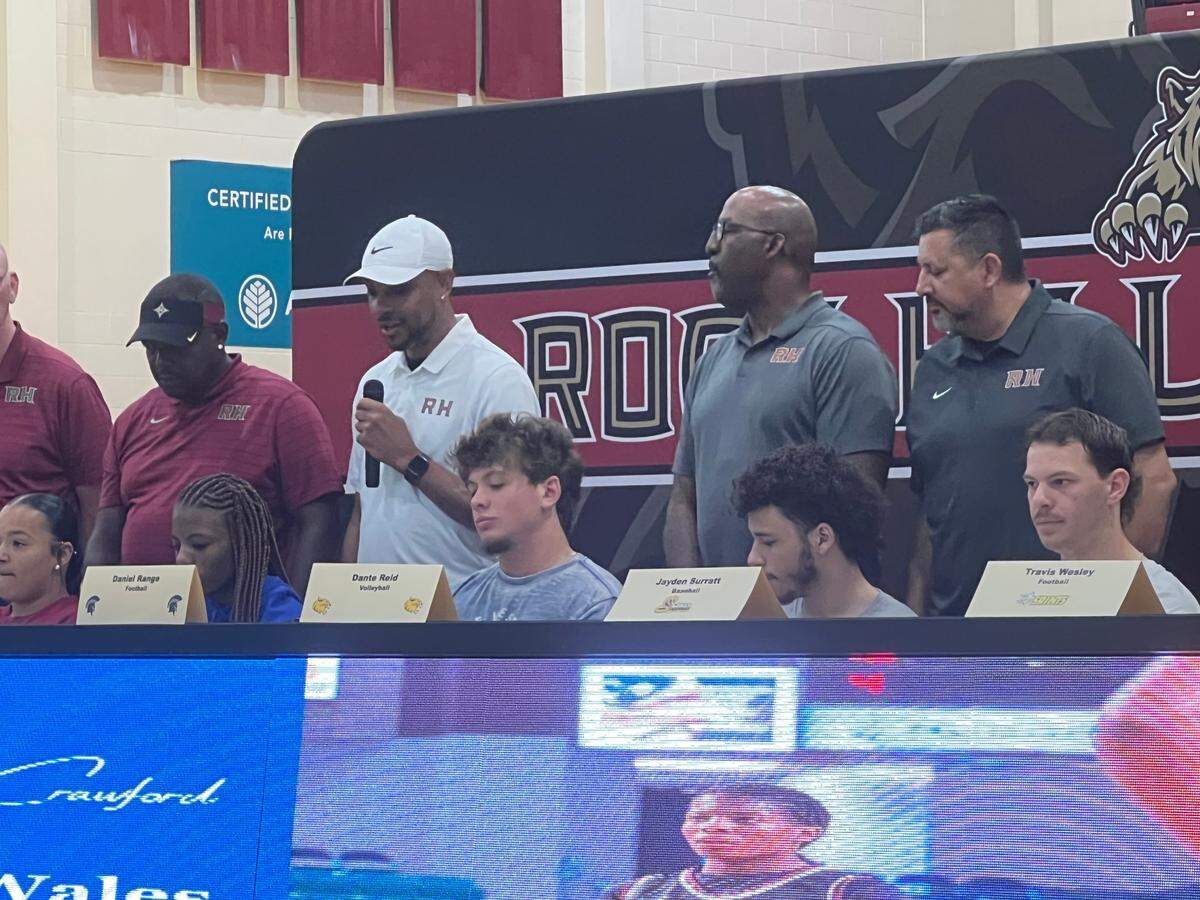 Kenny Orr (white shirt, white hat) speaks about De’Ashaj Crawford at Rock Hill’s signing day May 8.