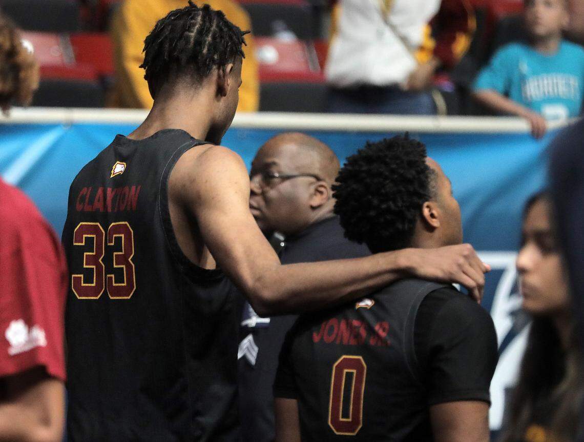 Winthrop’s Chase Claxton, left, and Russell Jones Jr. walk out of the stadium after being defeated by Longwood Sunday at the Big South Championship game.