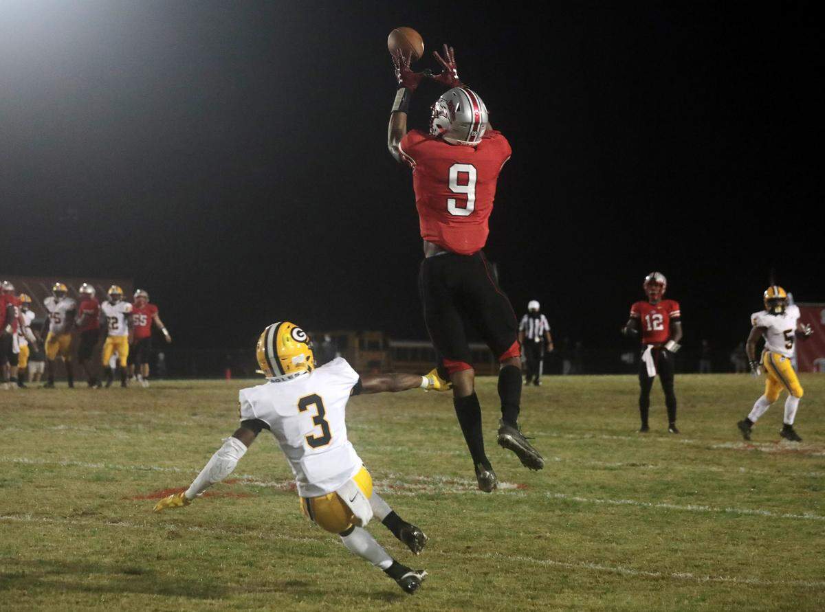 South Pointe’s O’Mega Blake reaches for the ball Friday as Greenwood’s Kendrick Makins tries to stop him. The Stallions defeated the Eages in Rock Hill.