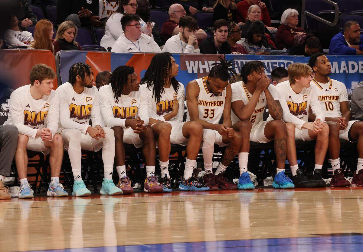 The Winthrop University men’s basketball team watches the end of the Big South tournament game against Longwood University Friday at High Point University.