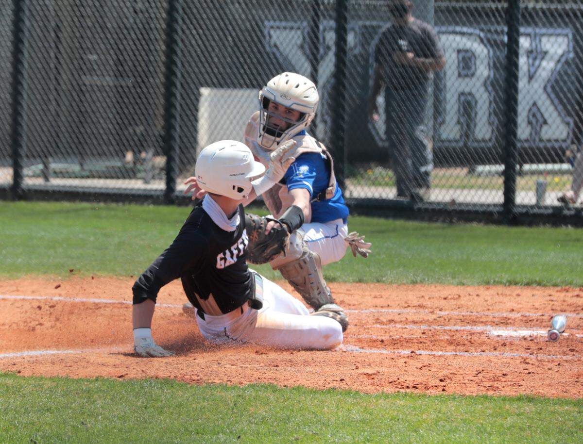 Gaffney’s Drew Medley slides into home as Indian Land’s Drew Endres tags him at home plate Tuesday.