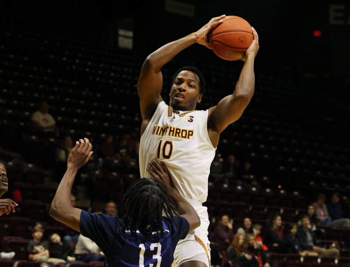 Winthrop’s Nick Johnson looks for an opening against Toccoa Falls’ Josh Parker Friday at the Winthrop Coliseum.