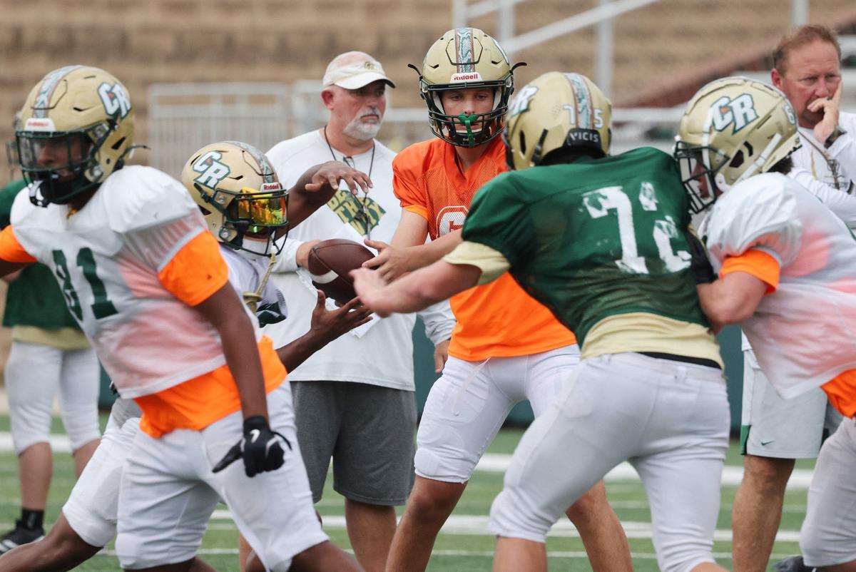 Catawba Ridge High School varsity football quarterback C.J. Couch, center, practices Tuesday at the school.