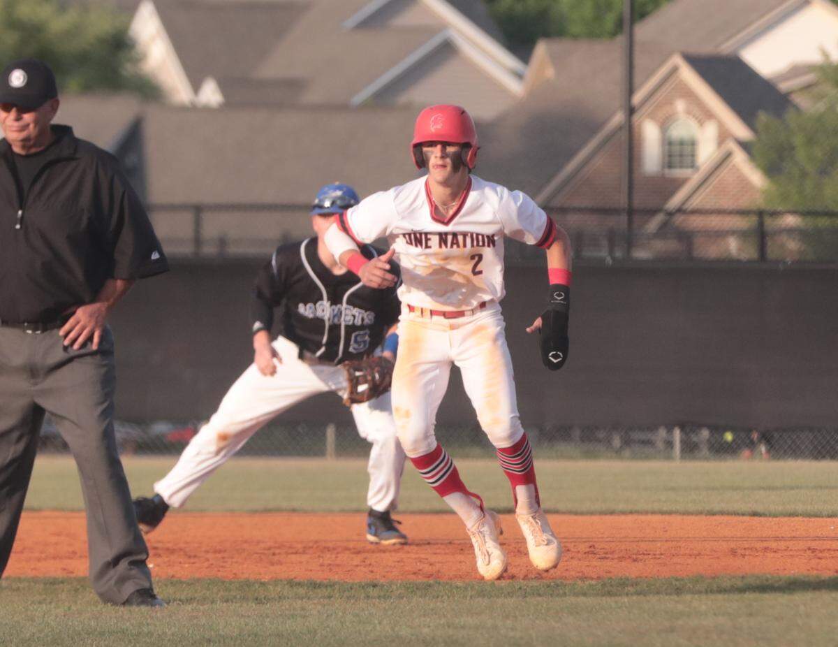 Nation Ford’s Connor Bowman leaves second base as Fort Mill’s Connor Rasmussen waits on the ball