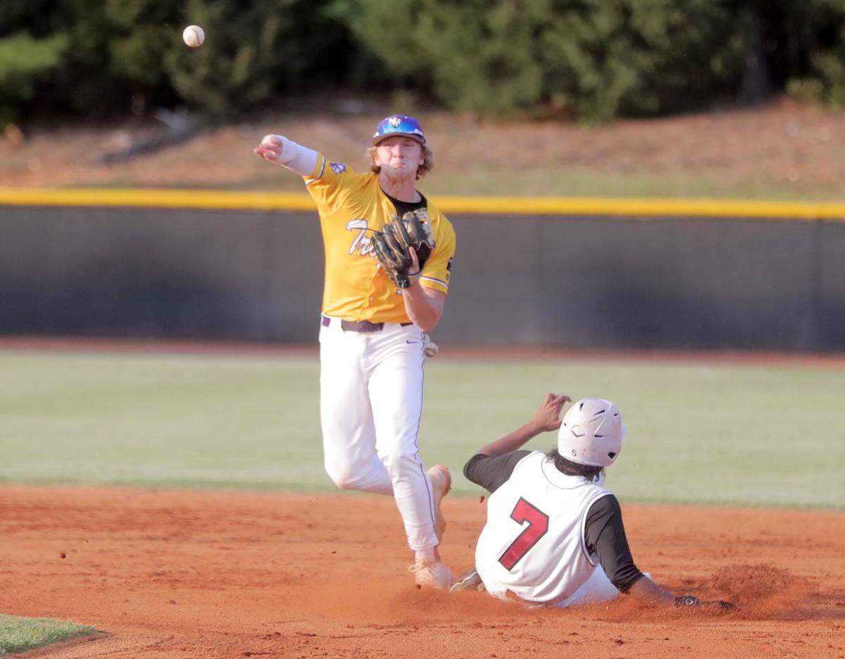 Northwestern’s Andrew Sands throws the ball back to first base as Rock Hill’s Kamari Moore slides into second.