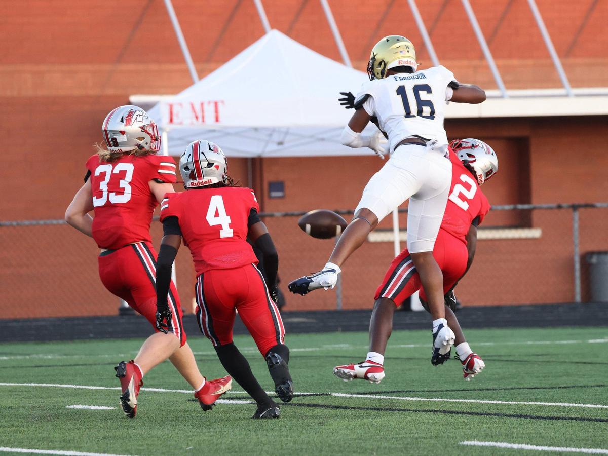 South Pointe’s C.J. Wherry (2) tries to catch the ball in the endzone with Brysen Ginn (33) and R.J. Bufford (4) while Spartanburg’s Keyvion Keenon tries to stop the play.