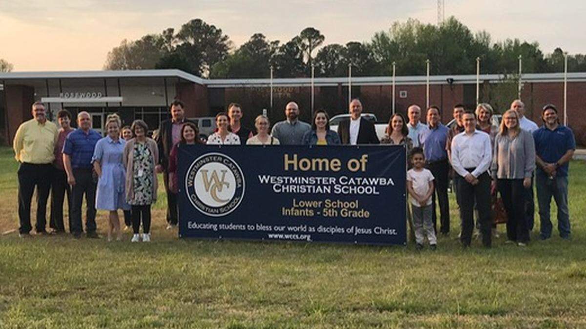 Westminster Catawba Christian School administration and board members pose in front of the Rosewood property in Rock Hill after the purchase was finalized in April 2022. WCCS plans to have its Lower School campus at the new Rosewood facility.