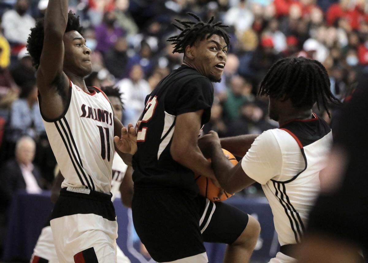 Great Falls’ Xavier Brown, middle, fights to get to the basket around Calhoun County’s Christian Zachary (11) and Emmanuel Pelzer, right.