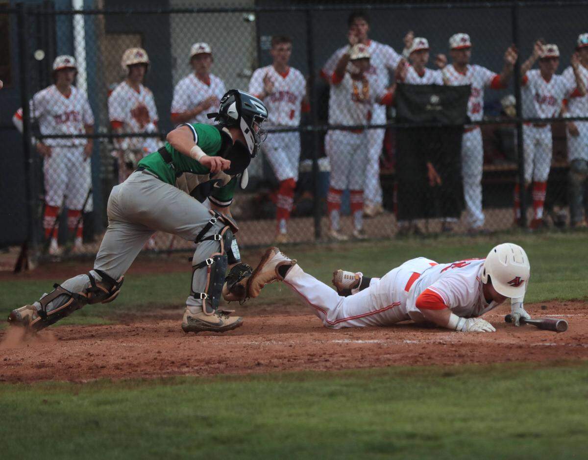 Andrew Jackson’s Kyle Percival falls to the ground as Legion’s Jack Killelea throws the ball to second base