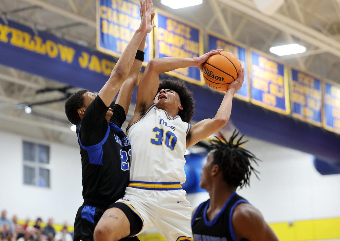 Fort Mill’s Logan Parker (30) shoots over Indian Land’s Brent Michael Terrell Thursday in Fort Mill.