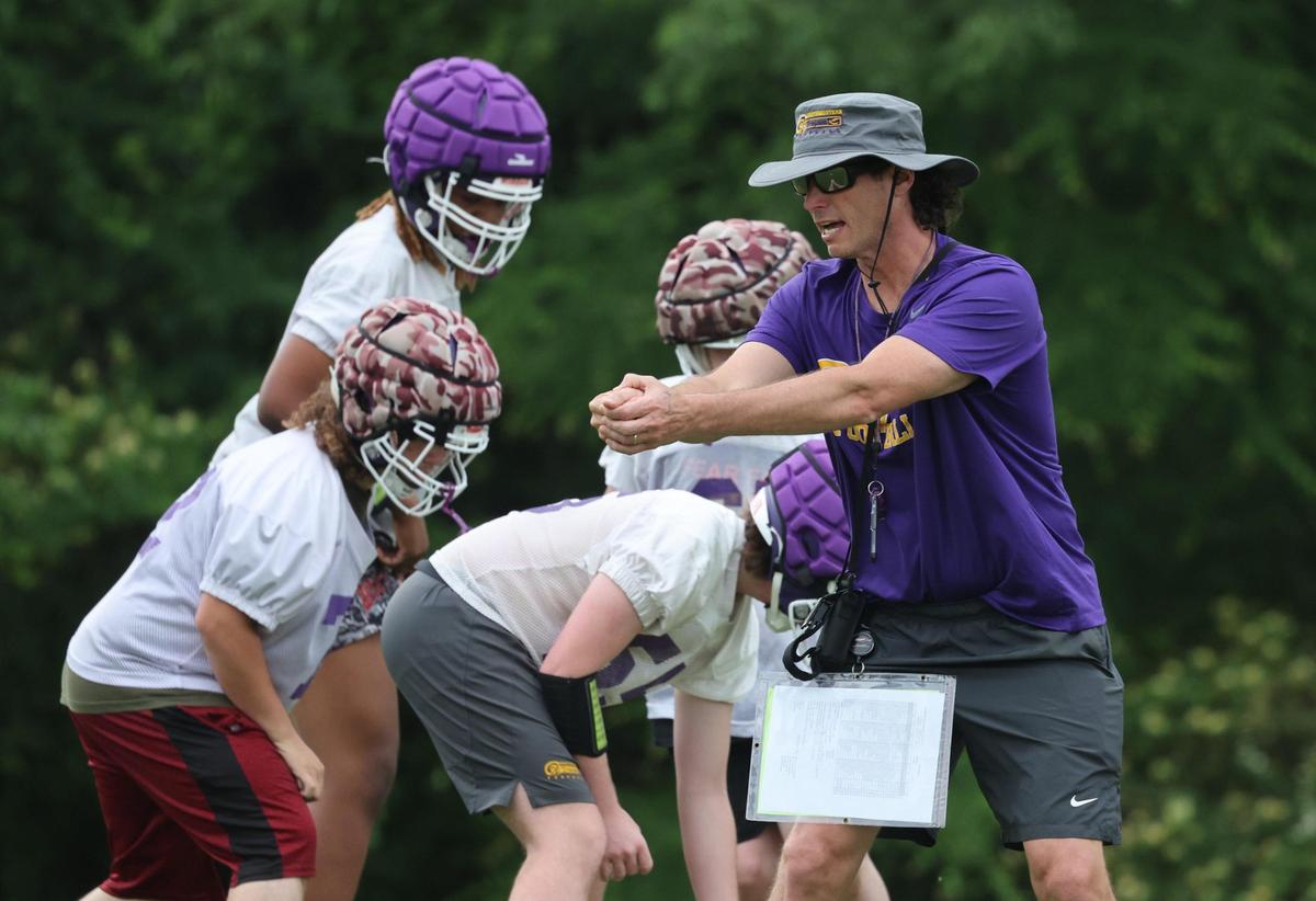 Northwestern High School head football coach Page Wofford coaches his team Thursday after school.