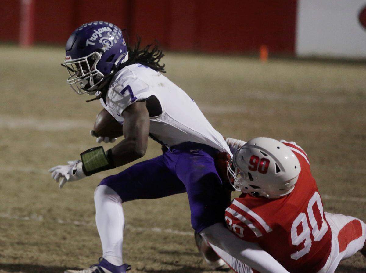 Northwestern’s Elijah Caldwell is pulled down Friday at the Class 4A Upperstate Championship game in Greenville, S.C.