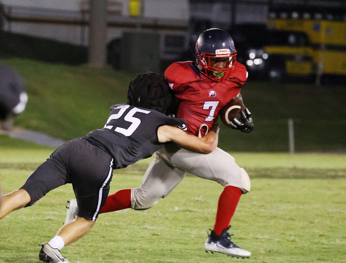 York’s Bennet Reeder (25) tries to tackle Chester’s Hudhaifah Taylor Friday at a scrimmage in Union.