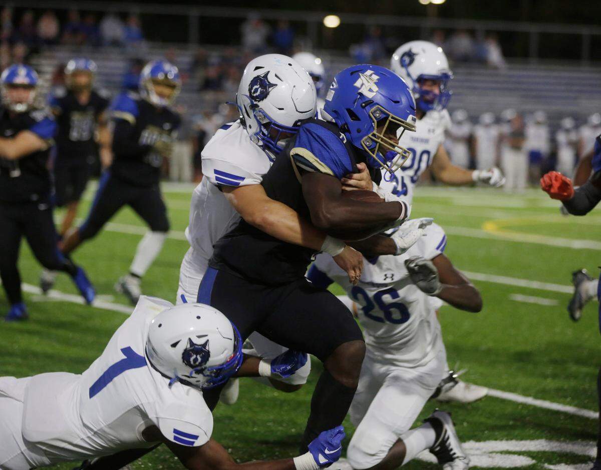 Indian Land’s Demarcus Peake is brought down by Parkwood’s Jaylin Meaders, center, Tim Boyd Jr. (1) and Kaleb Nixon (26) Friday, Sept. 23, 2022 In Indian Land.