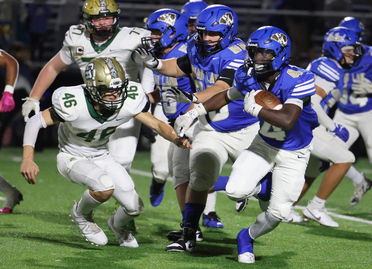 Indian Land’s Jamol Horton (4) carries the ball against Catawba Ridge’s Tyler Gindoff (46) in a 2024 game.