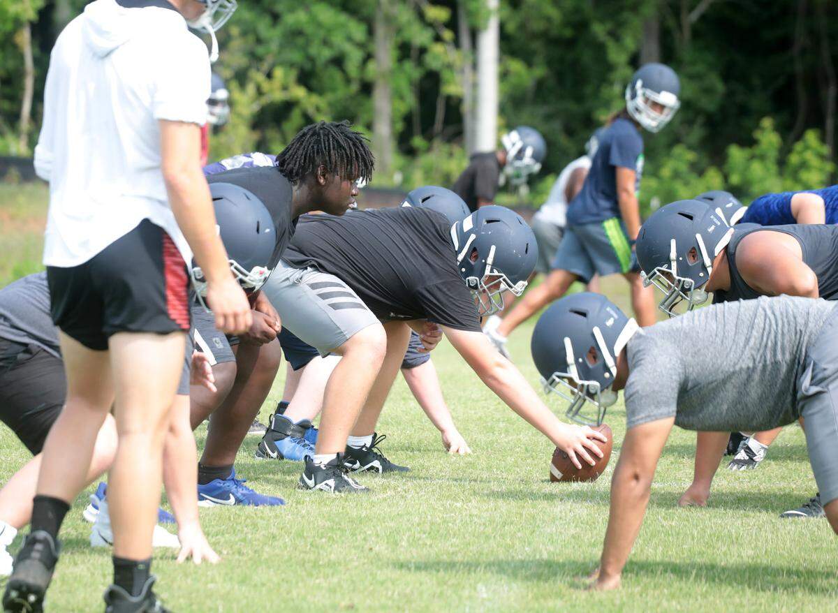 Legion Collegiate football players practice at the school in July. The Lancers have their 2021 season debut on Thursday night.