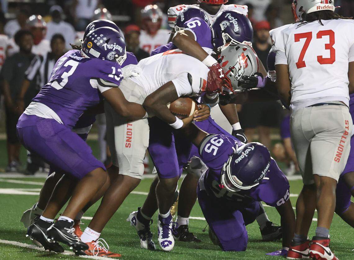 South Pointe's J'zavien Currence is brought down at the Northwestern-South Pointe game Friday, Sept. 12, 2025 in Rock HIll, S.C.