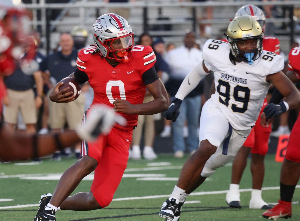 South Pointe’s J’Zavien Currence (0) is trailed by Spartanburg’s Cory Cheeks (99) during a 2024 game in Rock Hill.