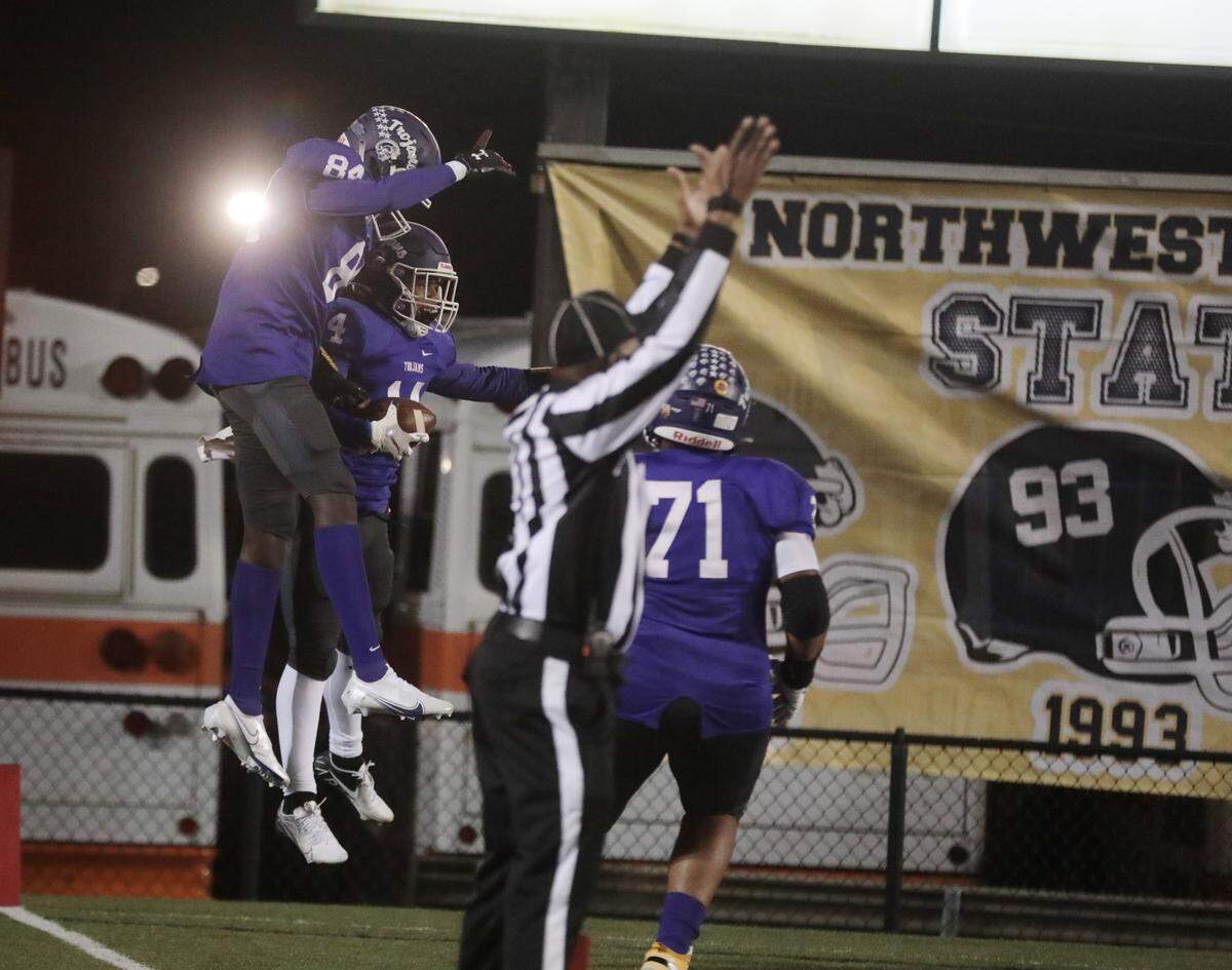 Northwestern’s William Brooks (84) and Turbo Richard (14) celebrate in the endzone Friday after Richard scores a touchdown in the first half of the game against Boiling Springs.